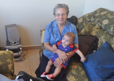 Yaira's little boy on the lap of his maternal great grandmother.