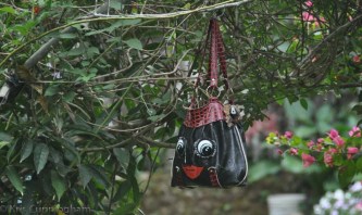 More whimsy - one of the many old purses hanging from this trellis.