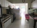 This is the spacious shared kitchen. There is a pass through space into the dining room, and beyond is the laundry area. There is no washing machine but there is a laundromat in the neighborhood.